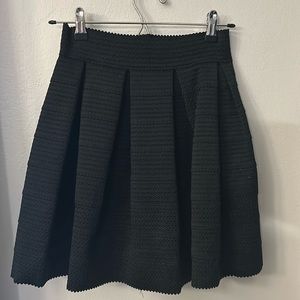 Black pleated skirt with textured pattern